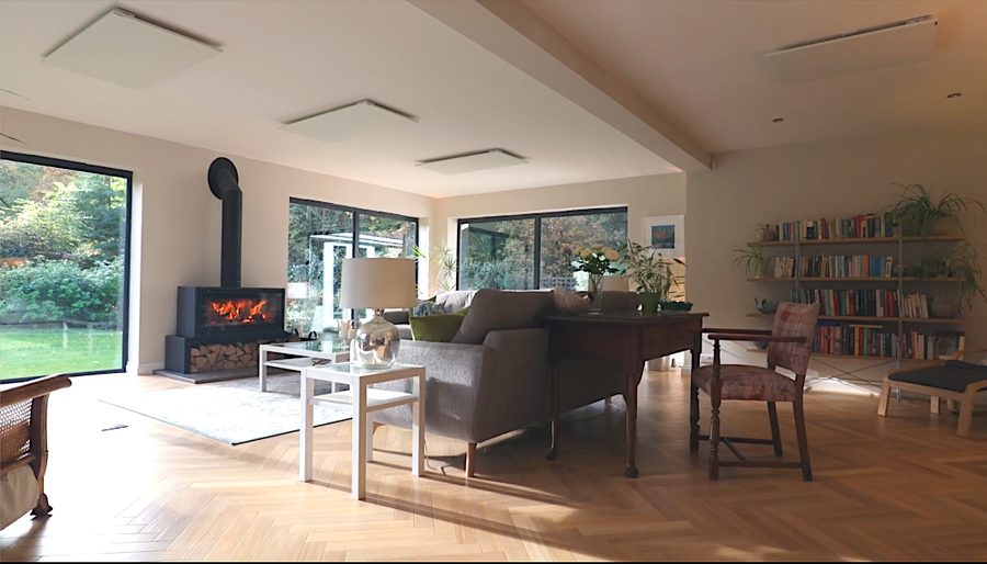 Living room in a rear extension with a wood burner and glazed doors onto the garden